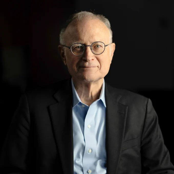 Color, vertical portrait of Mike Witherell, with black background. Photo by Christopher Michel.