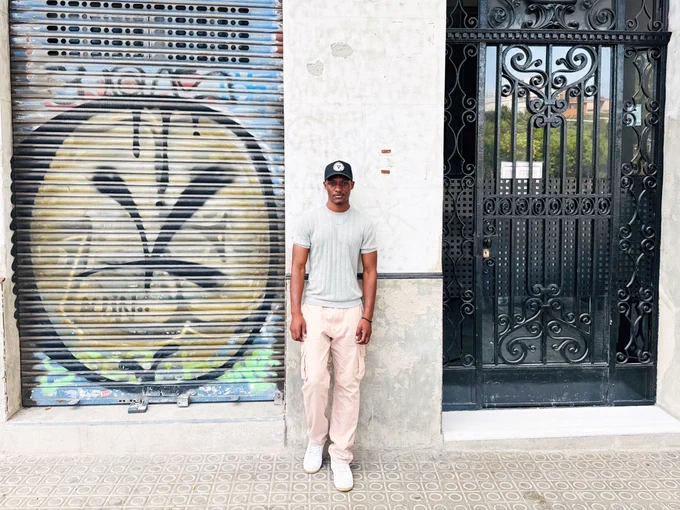 Fernand poses for a photo outside of a building in Barcelona
