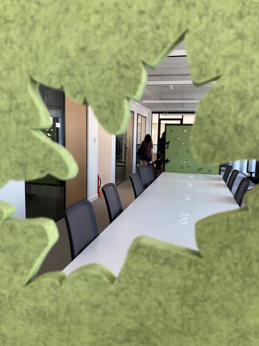 Looking through a leaf shaped screen window into a workspace