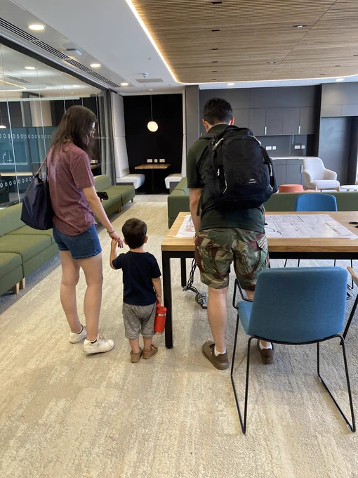 Two adults and a young future scientist looking around the building