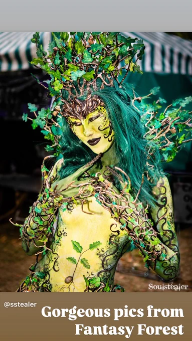 Oak Dryad Bodypainting look, with tree branches fashioned into a collar and headdress. Pale green stomach with an oak sapling and dark green lbs. with swirling painted branches around the arms.