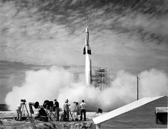 A group of people in the foreground photograph the launch of the Bumper 8 missile on July 24, 1950, the first rocket to be launched from Cape Canaveral.