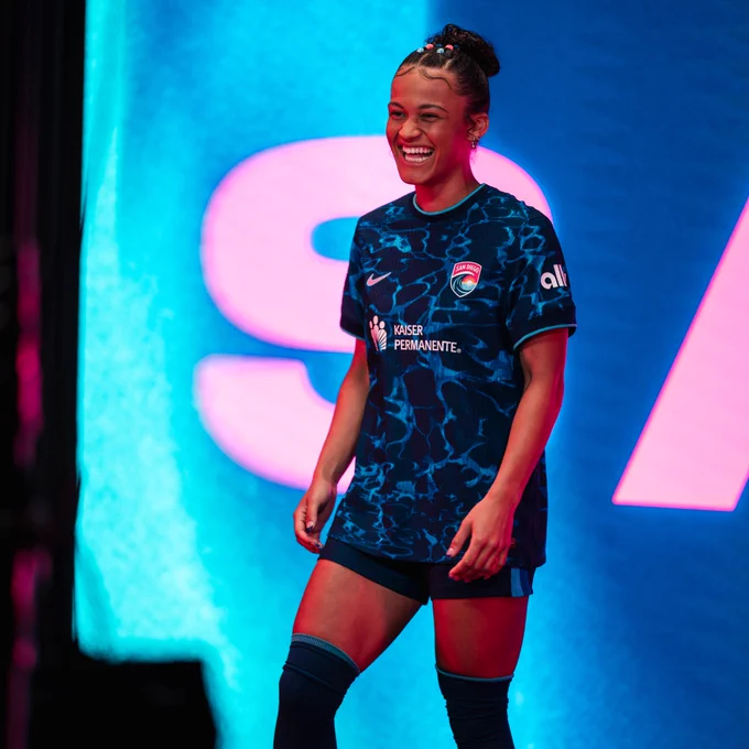 Trinity Armstrong smiles during a photo shoot. She is wearing the Altamar kit. 