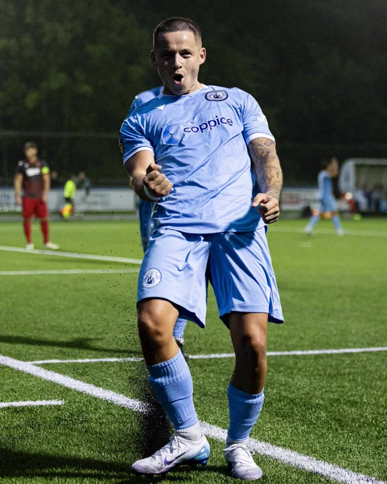 Calum Bateman celebrates scoring for Cambrian United against Treowen Stars.