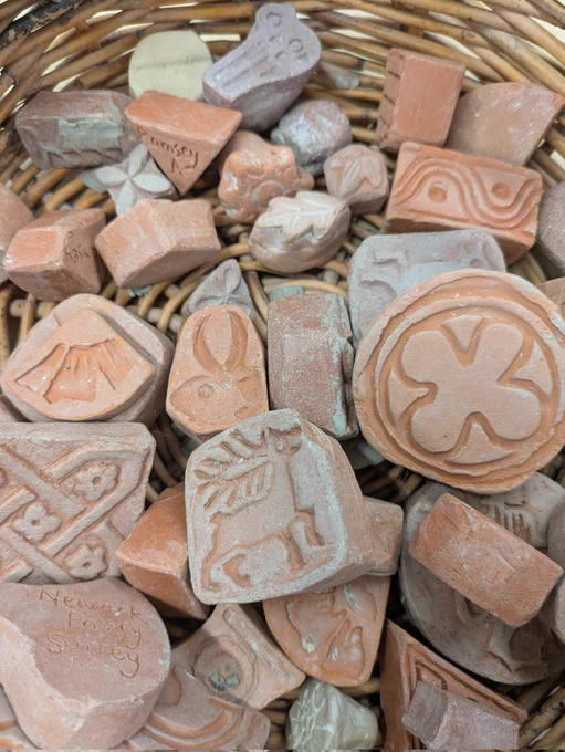 Various clay stamps in a basket