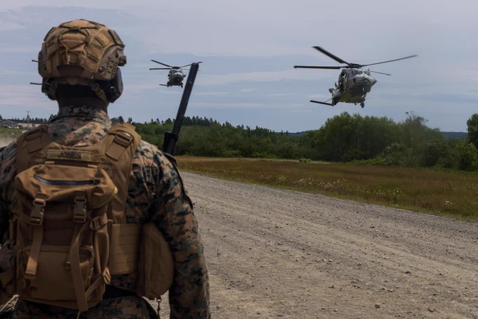 U.S. Marine Corps Staff Sgt. Terrance M. Jones, a joint terminal attack controller with 10th Marine Regiment, 2d Marine Division, observes Royal Netherlands Navy NH90 helicopters landing during an air assault at Cutler, Maine, July 10, 2025. Atlantic Alliance 2025 (AA25) is the premier East Coast naval integration exercise, featuring over 25 U.S. Navy and Marine Corps units alongside Dutch naval forces and British Royal Commandos. Spanning from North Carolina to Maine, AA25 will showcase a range of dynamic events including force integration, air assault operations, bilateral reconnaissance, naval strait transits, amphibious assault training, and a simulated war-at-sea exercise. (U.S. Marine Corps photo by Lance Cpl. Alexandria Serrano)