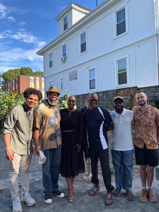 Rep. Ayanna Pressley poses for a photo with community members in Mattapan. 
