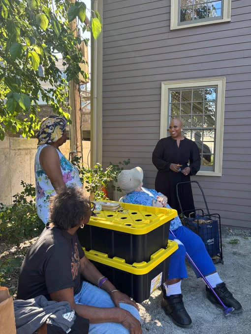 Rep. Ayanna Pressley talks with community members in Mattapan. 