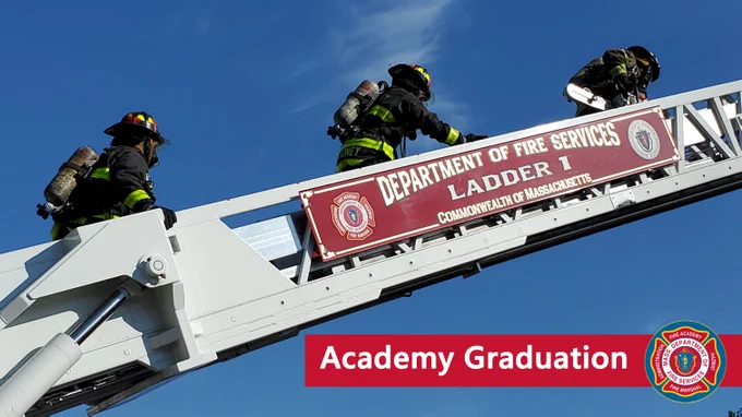 Three firefighters climbing an aerial ladder