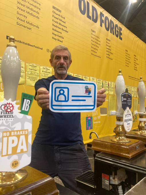 Blue Card being held up by a volunteer at a GBBF bar
