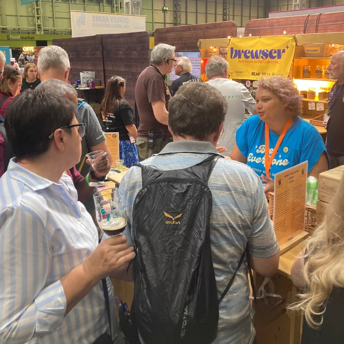Photo of Nix behind the Discovery Bar talking to festival goers.