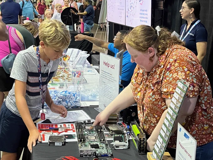 A visitor explores a hands-on science activity at the Ohio Department of Higher Education booth. 
