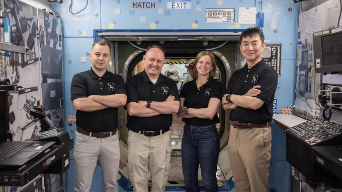 NASA's SpaceX Crew-11 crew members (from left to right: Oleg Platonov, Mike Fincke, Zena Cardman, and Kimiya Yui) stand inside a mockup space station at Johnson Space Center after a training session. Credit: NASA/Robert Markowitz