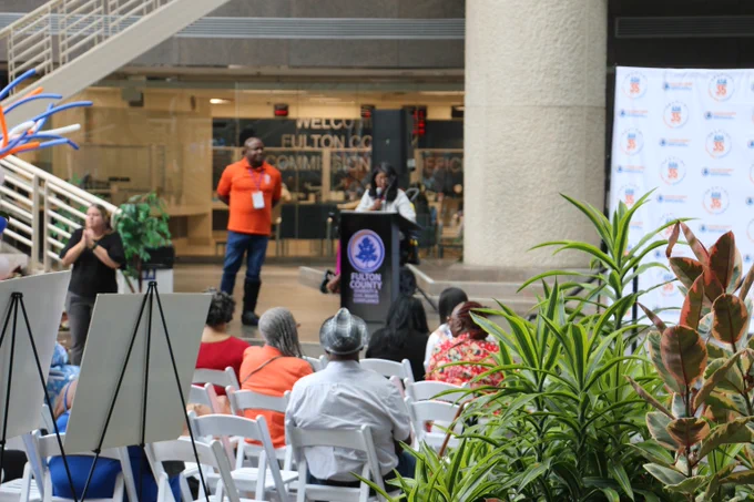 A speaker at the ADA 35th annual celebration, standing at the podium speaking.