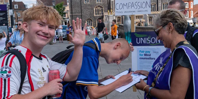 Members of the public sign the UNISON petition