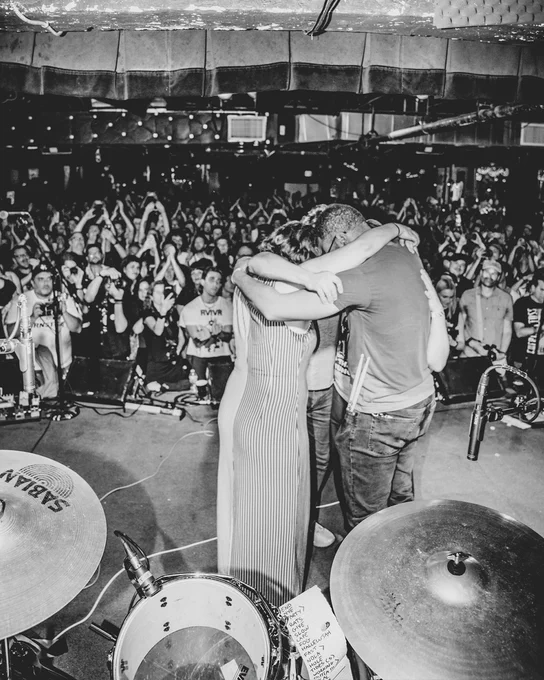 photo of Bad Moves huddling on stage