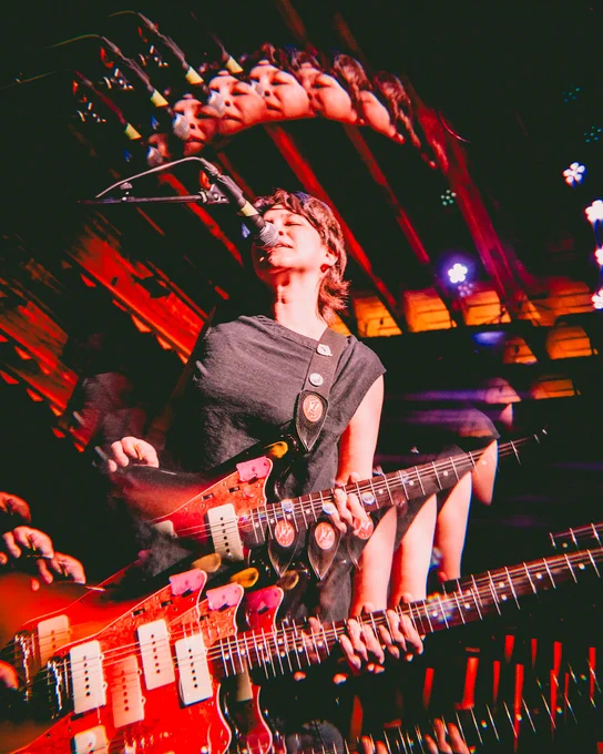 multiple exposure photo of Katie performing live with with a halo of images around them