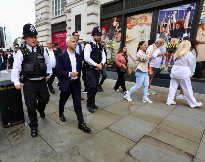 Mayor of London, Sadiq Khan walking with police officers through the West End streets.