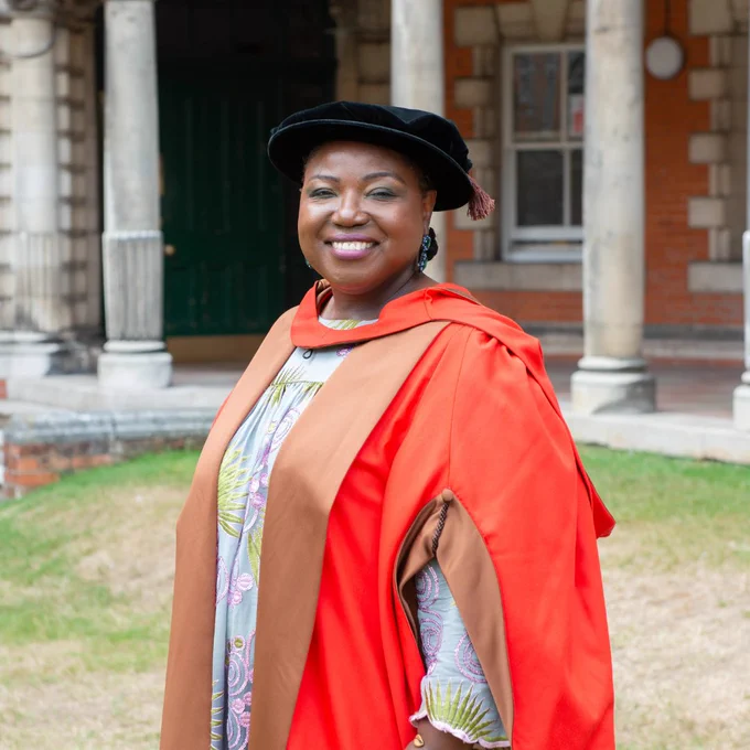 Tracie D Hall in graduation gown.

