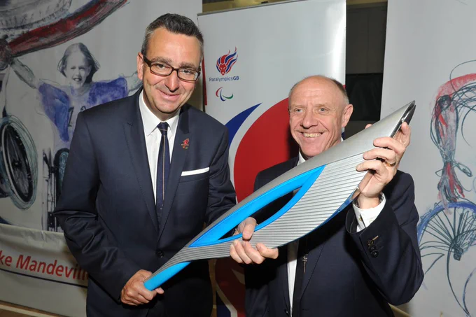 Tim Hollingsworth alongside former ParalympicsGB Chairman Tim Reddish hold the Sochi 2014 Paralympic Torch at the Heritage Flame Lighting Ceremony.