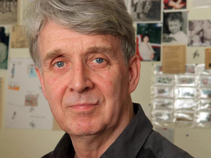 A photograph of author Allan Ahlberg. He has a full head of grey hair and is looking directly into the camera.