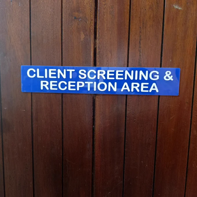 Door label reading "Client screening and reception area"