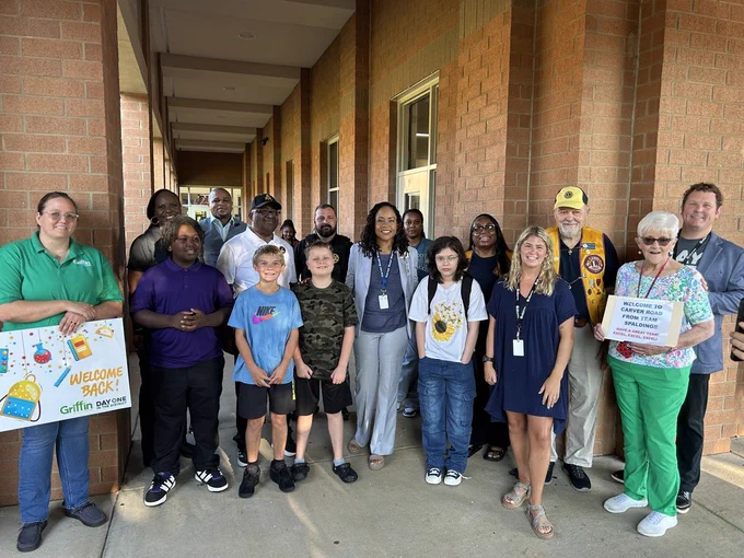 volunteers greeting students