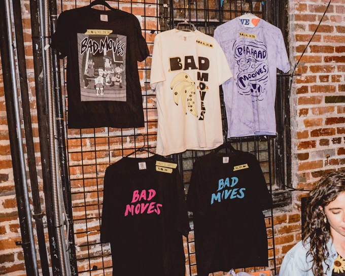 photo of Bad Moves shirts at the merch table
