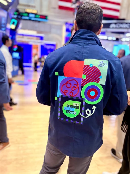 Close up of man wearing Figma branded trading jacket on the trading floor.