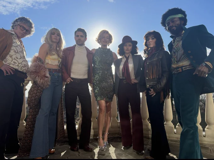The cast of Star Trek Strange New Worlds smiling in 60s inspired costumes