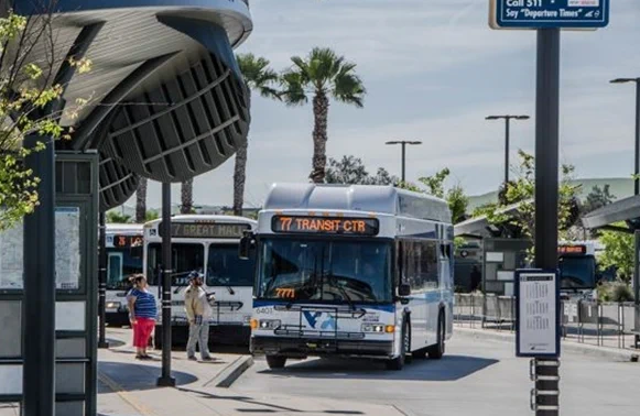busses lined up and parked at a depot.