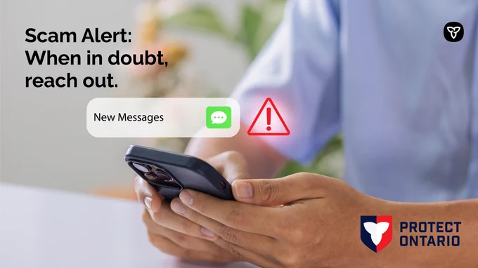 Phone with an alert notification : Copy : Scam Alert: When in doubt, reach out.