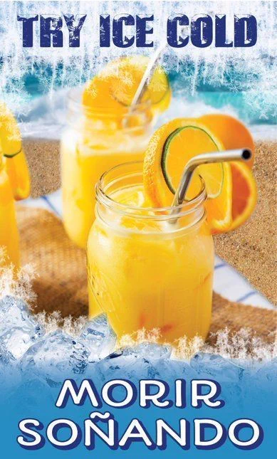 Close-up of two mason jars filled with Morir Soñando, a creamy orange drink, topped with orange and lime slices and metal straws. The jars rest on a sandy beach with ice cubes. Overlaid text reads 'Try Ice Cold' and 'Morir Soñando'.