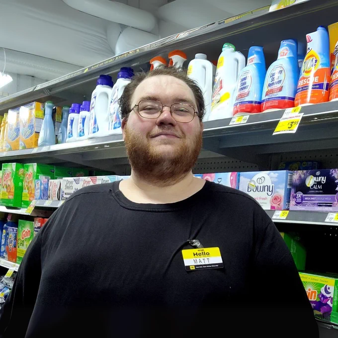 Employee smiling in store. 
