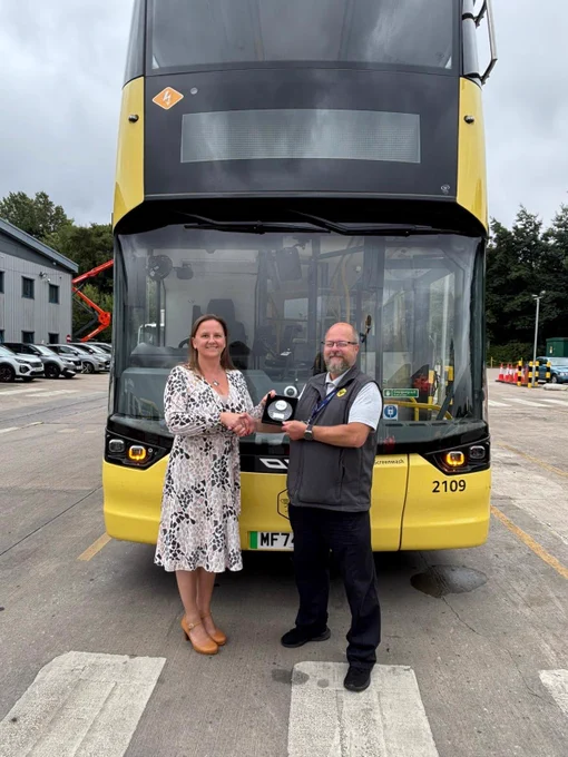 Go North West Bus Driver of the Year 2025 finalist, Chris, being presented with a commemorative trophy by a manager.
