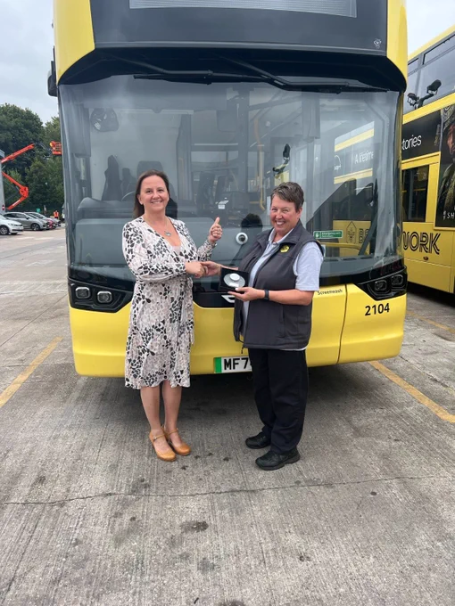 Go North West Bus Driver of the Year 2025 finalist, Karen, being presented with a commemorative trophy by a manager.