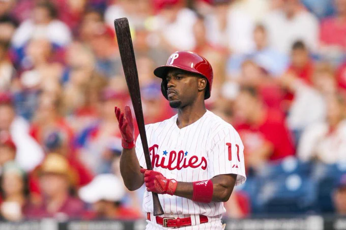 Jimmy Rollins with a bat in red pinstripes