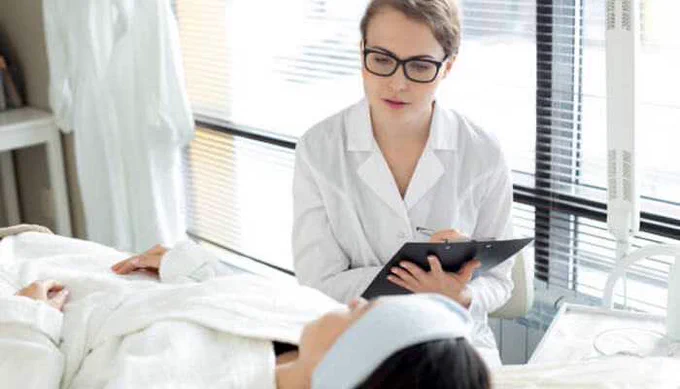 Med Spa professional consulting with a client during a treatment session in a modern, clean spa environment.