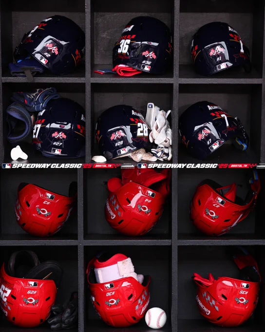 A scenic shot of the Braves and Reds helmets in the equipment rack. 