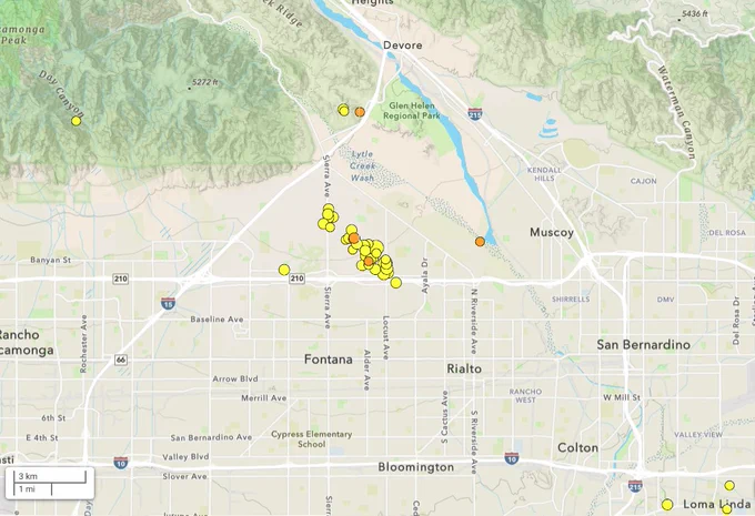 Map of San Bernardino County showing earthquake epicenters from a recent M4.3 near Rialto. Yellow and orange dots mark aftershocks, forming a northwest-trending cluster subparallel to the San Jacinto Fault.