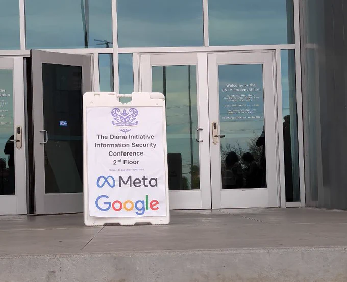 a sign for The Diana Initiative conference in front of a building