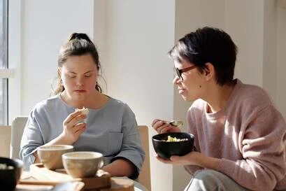 Image of two women eating a meal.