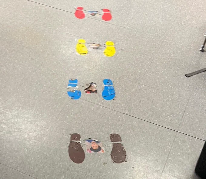 brown, blue, yellow, red cut out footprints with a child's picture in the middle of the feet. These line up to the door to help with pre-school students to line up at the door.