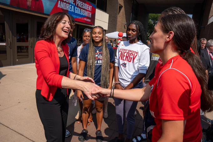 Me shaking hands with a student in a red shirt.