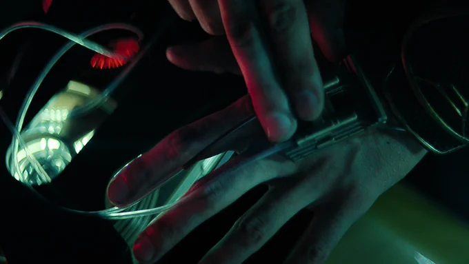 Lee Pace as Brother Day removing his nanites into the canister.