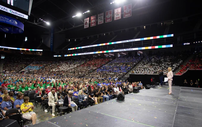 mayor deegan on stage talking to a very large arena of teachers 
