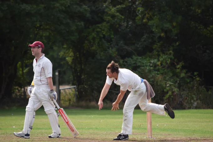 Mark bowls as the batter looks on