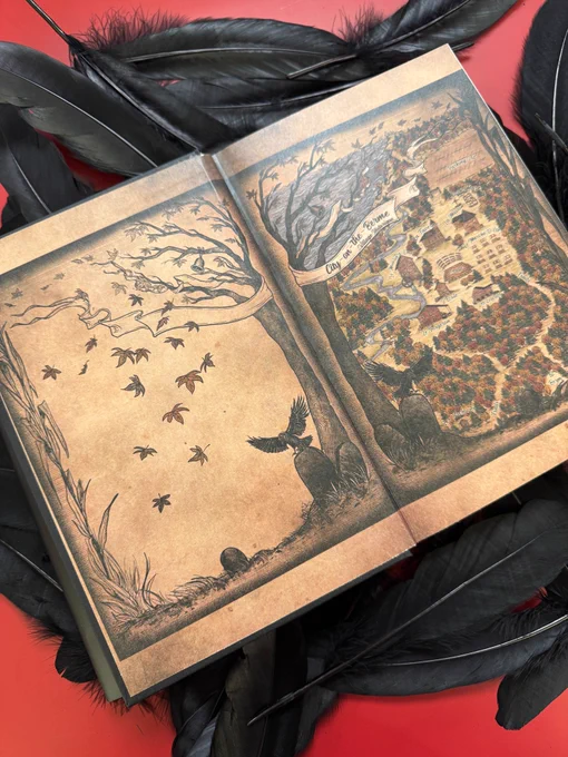 A copy of The Executioners Three by Susan Dennard resting on a red background covered in black feathers. It's open to the endpapers, which feature an illustrated map of the setting of the book.