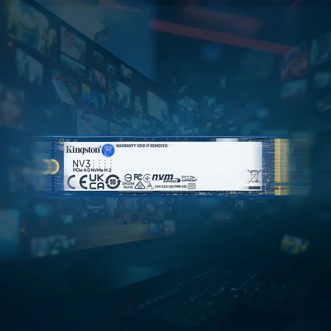 Close-up of a Kingston NV3 PCIe NVMe SSD, surrounded by a blurred background featuring computer screens displaying various graphics.