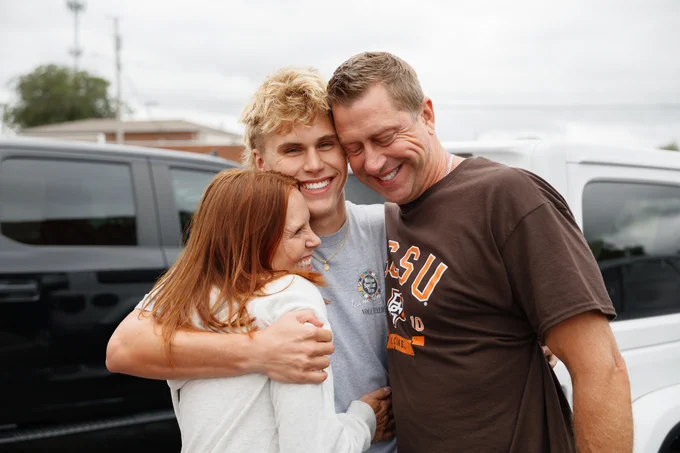 Three people embracing and smiling joyfully at BGSU Move-in